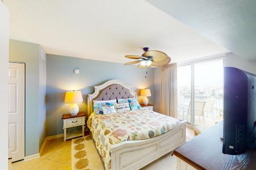 a bedroom with a bed and a ceiling fan at The Terrace at Pelican Beach 504 in Destin