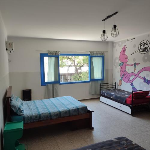 a bedroom with two beds and a window at rafa's house in Mendoza