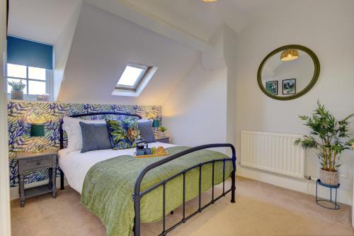 a bedroom with a bed and a mirror at Regency Nest by Spa Town Property - Stylish 3 Bedroom Apartment on 2 Floors, Central Leamington Spa in Leamington Spa