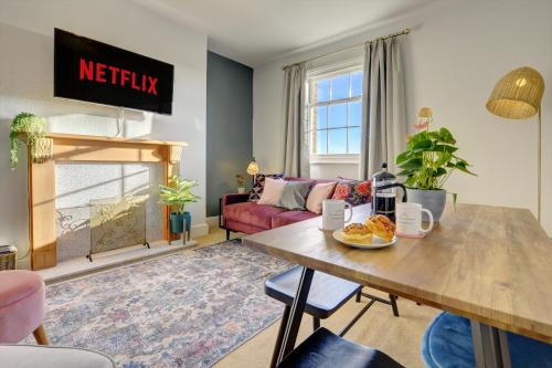 a living room with a table and a couch at Regency Nest by Spa Town Property - Stylish 3 Bedroom Apartment on 2 Floors, Central Leamington Spa in Leamington Spa