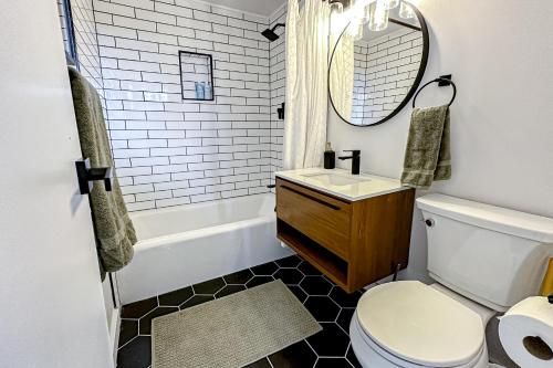 a bathroom with a toilet and a sink and a mirror at The Golden Moose Chalet in Grand Lake