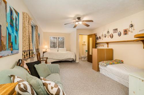a living room with a couch and a bed at The River Retreat in Thompsonville