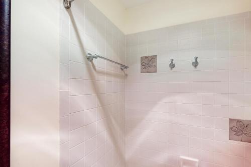 a bathroom with a shower with pink tile at Skyland Studio in Crested Butte