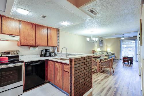 a kitchen with wooden cabinets and a dining room at Hilton Head Cabanas 14 in Hilton Head Island