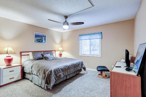 a bedroom with a bed and a flat screen tv at Hilton Head Cabanas 14 in Hilton Head Island
