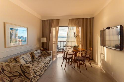 a living room with a couch and a table at Jurerê Beach Village - OFICIAL in Florianópolis