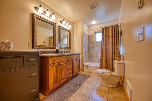 a bathroom with a sink and a toilet and a mirror at Tranquil Aspens in McCall