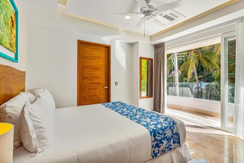 a bedroom with a bed and a large window at Blue Horizon 701 in Puerto Vallarta