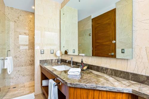 a bathroom with a sink and a mirror at Blue Horizon 701 in Puerto Vallarta