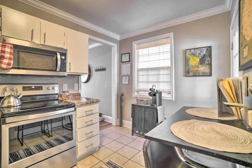 a kitchen with a stove top oven next to a table at Fire Pit and Yard Charming Port Royal Home! in Port Royal