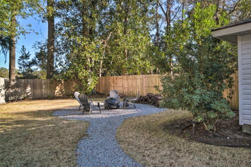 a patio with two chairs and a table in a yard at Fire Pit and Yard Charming Port Royal Home! in Port Royal