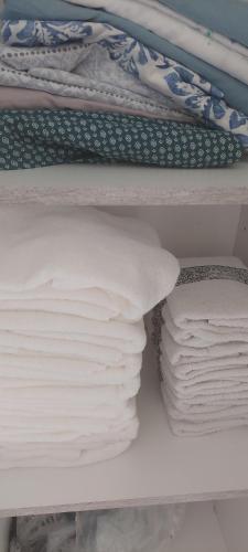 a shelf filled with lots of white sheets and towels at Casa de playa en jose ignacio uruguay. in José Ignacio