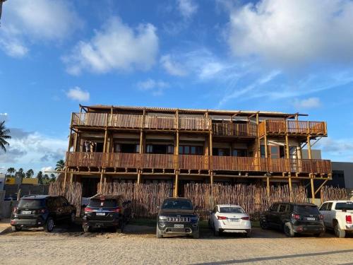 a building with cars parked in front of it at Kaha Mar - Patacho in Pôrto de Pedras