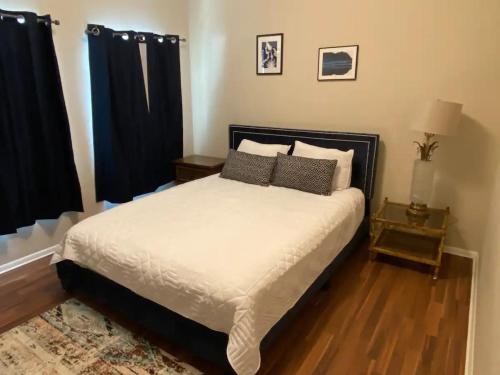 a bedroom with a large bed with black curtains at The Lofts at Myrtle in El Paso