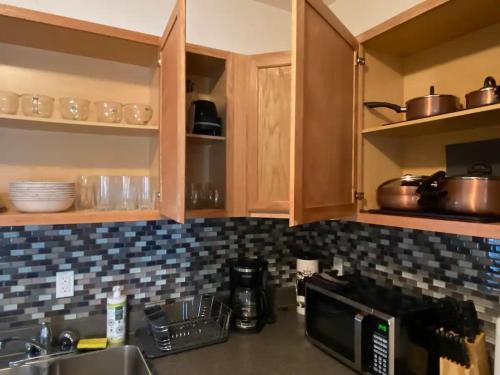 a kitchen with wooden cabinets and a counter top at The Lofts at Myrtle in El Paso