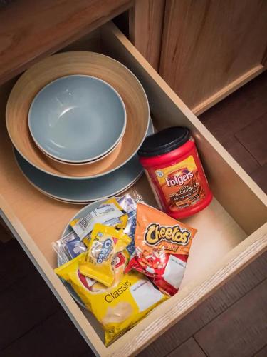 a drawer with snacks and a plate on a table at The Lofts at Myrtle in El Paso