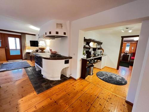 a kitchen and living room with a table in a room at Haus Diel - Premium Apartments mit Küche in Pettneu am Arlberg