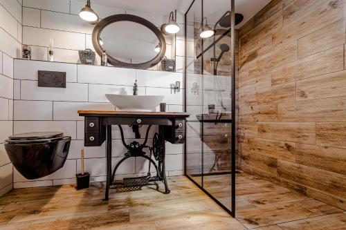 a bathroom with a sink and a mirror at Chata U Tří lišek - na samotě u lesa 