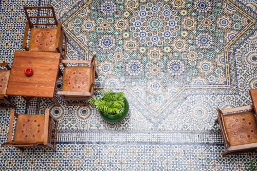 a tile floor with a plant in a pot on it at Dar Shaeir in Rabat