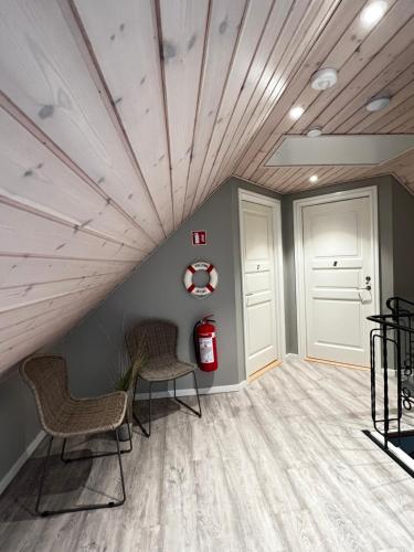 a room with two chairs and a ceiling with a fire extinguisher at Jerup Bed & Breakfast in Jerup