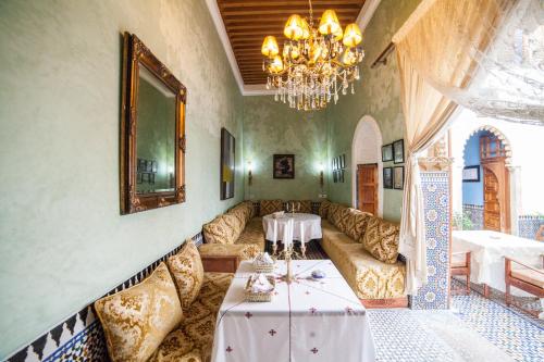 a living room with a couch and a table at Dar Shaeir in Rabat