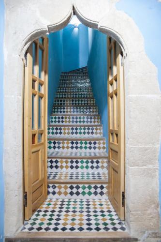 a staircase leading up to a room with a tiled floor at Dar Shaeir in Rabat