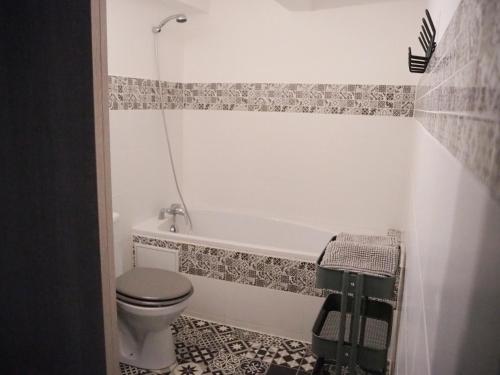 a bathroom with a toilet and a bath tub at Maison Salamandre in Remoulins