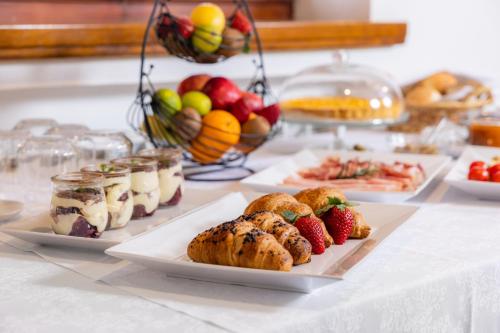 a table topped with plates of food and fruit at Štok - Rooms, Wine & Restaurant - Marezige, Koper in Koper