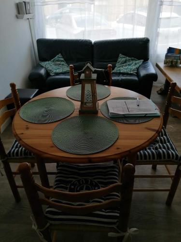 a wooden table in a living room with a couch at Julie's Home in Bray-Dunes