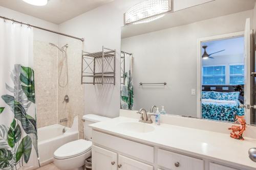a bathroom with a sink and a toilet and a shower at Hau'Oli at Waikoloa Hills #902 in Waikoloa Village