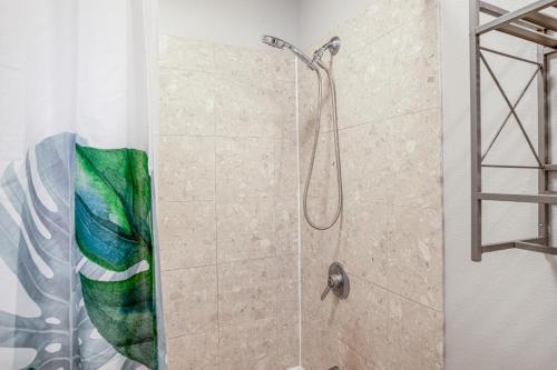 a bathroom with a shower with a glass door at Hau'Oli at Waikoloa Hills #902 in Waikoloa Village