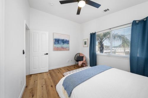 a bedroom with a bed and a ceiling fan at Steps Away From Pismo Beach with Poker, Foosball, FREE EV Charger, and Bikes in Oceano
