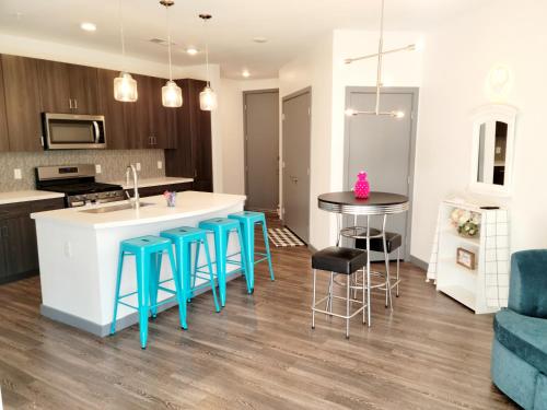a kitchen and living room with a island and stools at High rise Near UNLV and Strip in Las Vegas