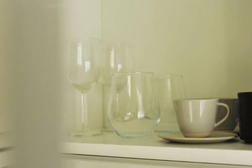 a group of wine glasses and a cup on a shelf at No. 5 Bligh's Yard in Canterbury