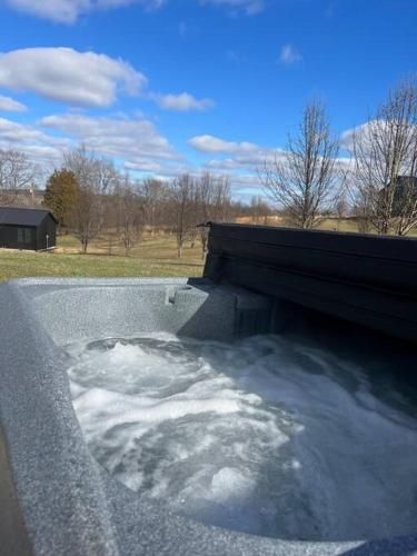 a tub filled with snow next to a bench at Bourbon Barrel Cottages #2 of 5 on Kentucky trail in Lawrenceburg