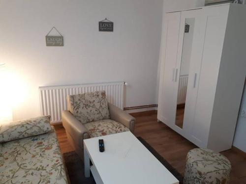 a living room with a couch and a table at Apartment Ana in Slavonski Brod