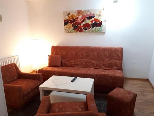 a living room with a couch and a table at Apartment Ana in Slavonski Brod