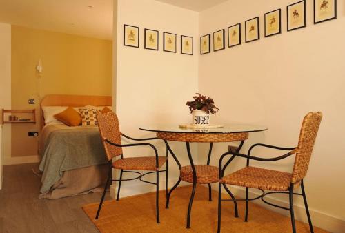 a table and chairs in a room with a bed at No. 4 Bligh's Yard in Canterbury