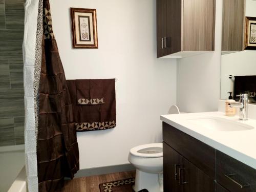 a bathroom with a toilet and a sink at High rise Near UNLV and Strip in Las Vegas