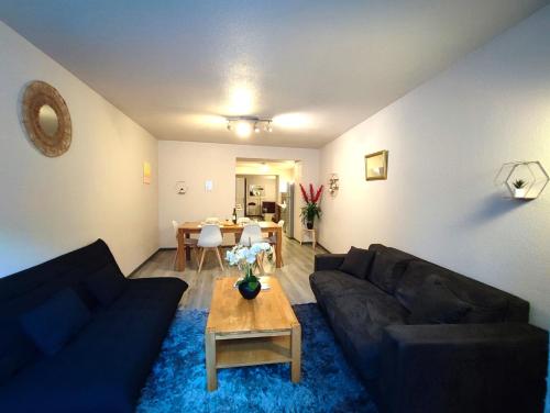 a living room with a couch and a table at Le Bokeh - Face à la Cité Médiévale in Carcassonne