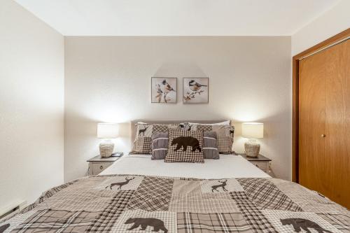 a bedroom with a bed and two night stands at Ptarmigan's Roost in Whitefish
