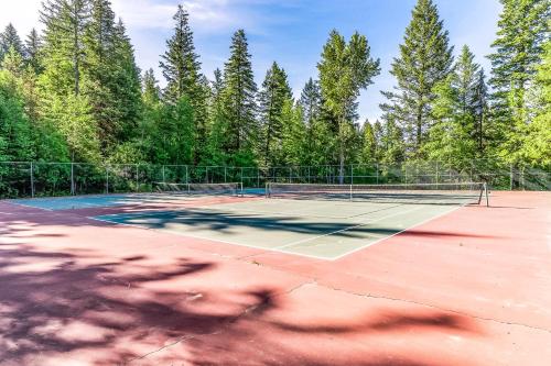 a tennis court with trees in the background at Ptarmigan's Roost in Whitefish