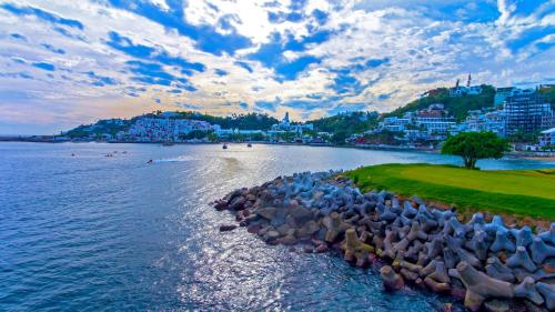 a large body of water with a bunch of rocks at Las Hadas by Brisas in Manzanillo