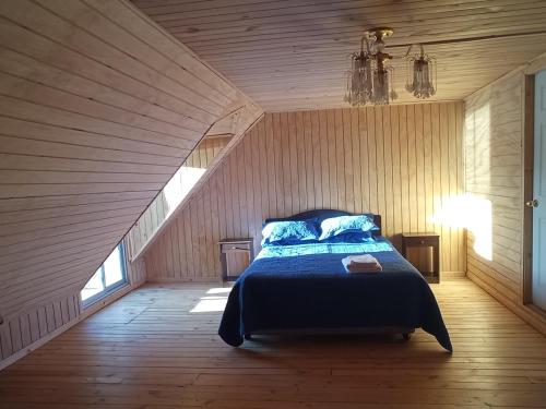 a bedroom with a bed in a attic at Peumayen in Quellón