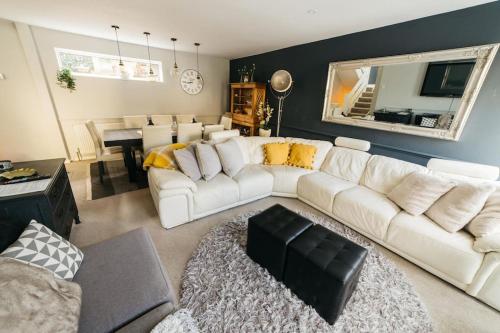 a living room with a white couch and a table at Holloway House in Bath