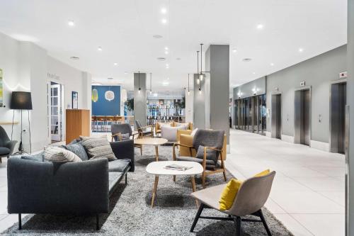 a lobby of a store with couches and chairs at Best Western Plus Airport Hotel in Copenhagen