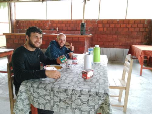 two men sitting at a table in a restaurant at Amazon Lodge and Expeditions in Iquitos