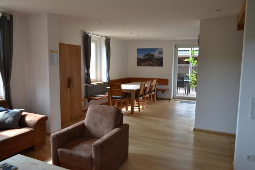 a living room with a couch and a table and chairs at Apartments in Fischbach bei Dahn - Pfälzerwald 42914 in Fischbach
