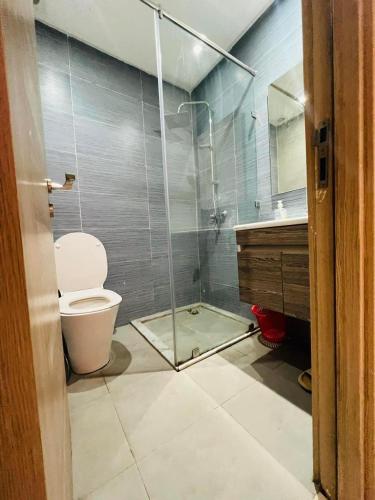 a bathroom with a shower with a toilet and a sink at Islane in Agadir