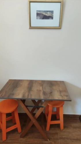 a wooden table with two chairs and a picture at Olala house in Sucre